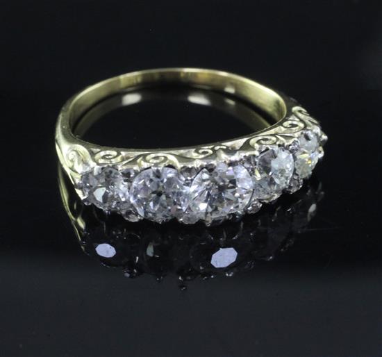 A gold and graduated five stone diamond ring, size M.